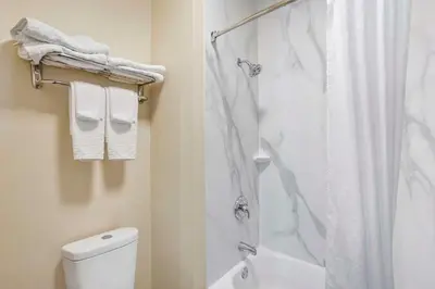a white bathroom with a shower and a toilet at Best Western Carlisle in Carlisle