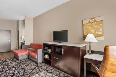 a hotel room with a television and a living room at Best Western Carlisle in Carlisle