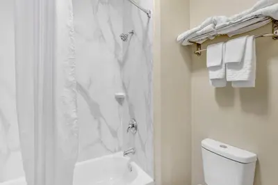 a white bathroom with a shower and a toilet at Best Western Carlisle in Carlisle
