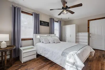 a bedroom with a bed and a ceiling fan at Pocono Retreat Movies Games Spacious in Long Pond