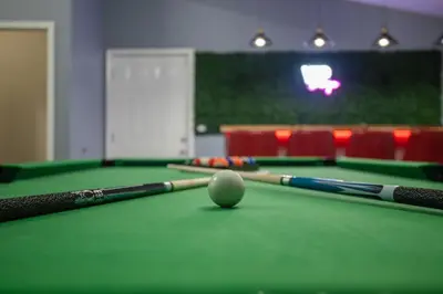 a billiard table with two cue balls on it at Pocono Retreat Movies Games Spacious in Long Pond
