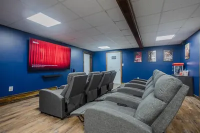 a waiting room with chairs and a red screen at Pocono Retreat Movies Games Spacious in Long Pond