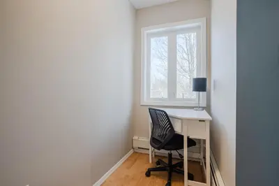 a desk and a chair in a room with a window at Pocono Retreat Movies Games Spacious in Long Pond