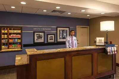 a man standing at the counter of a pharmacy at Hampton Inn & Suites Philadelphia/Bensalem in Bensalem