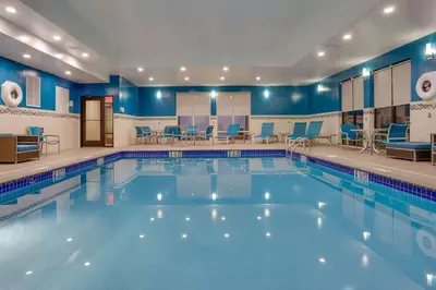 a pool in a hotel room with blue walls at Hampton Inn & Suites Philadelphia/Bensalem in Bensalem