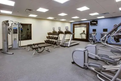 a gym with several treadmills and cardio machines at Hampton Inn & Suites Philadelphia/Bensalem in Bensalem