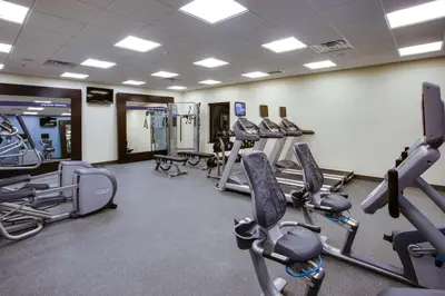 a gym with several treadmills and cardio machines at Hampton Inn & Suites Philadelphia/Bensalem in Bensalem