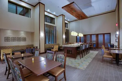a dining room with wooden tables and chairs and tablesktop at Hampton Inn & Suites Philadelphia/Bensalem in Bensalem