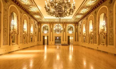 a large room with a chandelier and a wooden floor at Hotel Du Pont in Wilmington