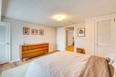 a bedroom with a large bed and a dresser at 7 Mi to Newark Montclair Vacation Rental in Montclair