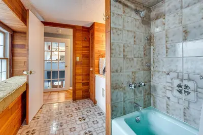 a bathroom with a blue tub and a shower at 7 Mi to Newark Montclair Vacation Rental in Montclair