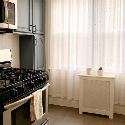 a kitchen with a stove and a window at Spacious 4BR near NYC with Parking, 10min MetLife, 20min Times Sq in North Bergen
