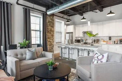 a living room with two couches and a table at A Luxury Urban 1BR Queen Bed-Parking - Heart of Historic Germantown - Temple & LaSalle -106- Stay Long Term! in Philadelphia