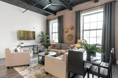 a living room with a couch and a table at A Luxury Urban 1BR Queen Bed-Parking - Heart of Historic Germantown - Temple & LaSalle -106- Stay Long Term! in Philadelphia