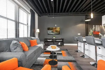 a living room with a couch and a table at Luxury Urban 1BR King Bed-Parking - Heart of Historic Germantown - Temple & LaSalle -105- Stay Long Term! in Philadelphia
