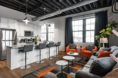 a living room with a couch and a kitchen at Luxury Urban 1BR King Bed-Parking - Heart of Historic Germantown - Temple & LaSalle -105- Stay Long Term! in Philadelphia