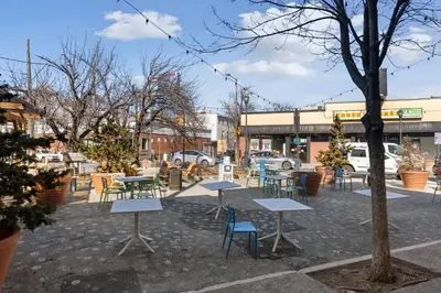 a group of tables and chairs in a parking lot at Fitler Square GEM - 3 Bedrooms in Philadelphia