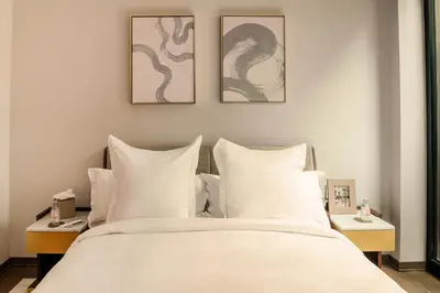 a bedroom with a large bed with white pillows at Maison Hudson in New York