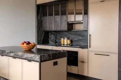 a kitchen with white cabinets and a bowl of fruit on a counter at Maison Hudson in New York