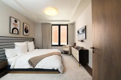 a bedroom with a bed and a desk and a window at Maison Hudson in New York