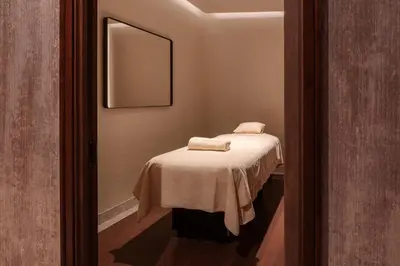 a small room with a bed with a mirror at Maison Hudson in New York
