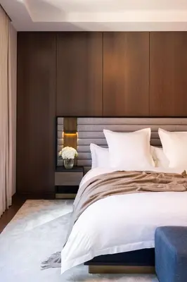 a bedroom with a large bed with a wooden headboard at Maison Hudson in New York
