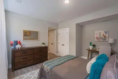 a bedroom with a bed and a wooden dresser at PRISTINE 3 bdrm - Garage Parking - Close to UPENN in Philadelphia