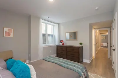 a bedroom with a bed and a dresser and a window at PRISTINE 3 bdrm - Garage Parking - Close to UPENN in Philadelphia