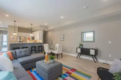 a living room with a couch and a table at PRISTINE 3 bdrm - Garage Parking - Close to UPENN in Philadelphia