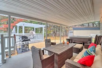 a patio with a table and chairs and a grill at Oasis Hot Tub Pool Game Room in Saylorsburg