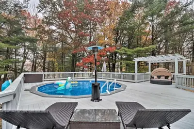 a patio with a pool and chairs and a gazebo at Oasis Hot Tub Pool Game Room in Saylorsburg