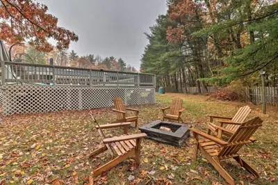 a group of chairs sitting around a fire pit at Oasis Hot Tub Pool Game Room in Saylorsburg