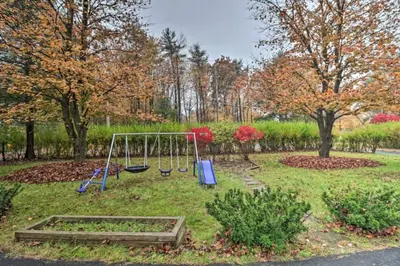 a playground with a swing set in a park at Oasis Hot Tub Pool Game Room in Saylorsburg