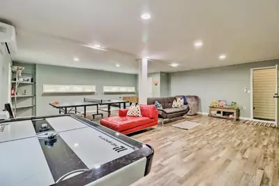a living room with a ping pong table at Oasis Hot Tub Pool Game Room in Saylorsburg