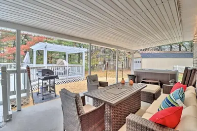 a patio with a table and chairs and a grill at Oasis Hot Tub Pool Game Room in Saylorsburg