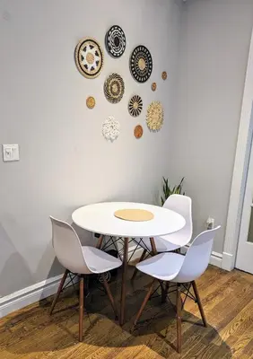 a table and chairs with plates on the wall at Private Room at a 3 bedroom Apt at the heart of East Village - shared apartment in New York