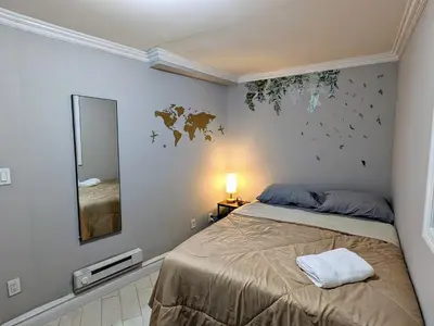 a bedroom with a bed and a mirror at Private Room at a shared Apartment at the Heart of East Village in New York