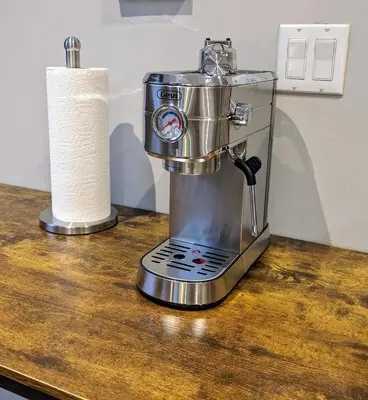 a coffee maker on a counter with a roll of paper towels at Lovely Room at 3 bedroom Apt at the heart of East Village in New York