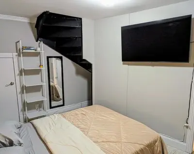 a bedroom with a bed and a flat screen tv at Lovely Room at 3 bedroom Apt at the heart of East Village in New York