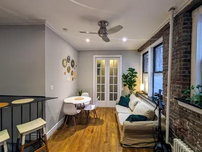a living room with a couch and a table at Lovely Room at 3 bedroom Apt at the heart of East Village in New York