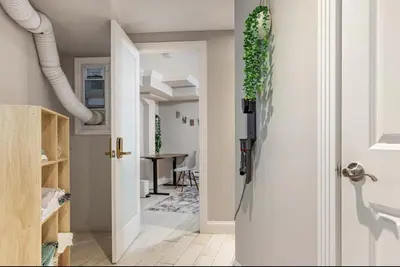 a hallway with a door leading to a dining room at Lovely Room at 3 bedroom Apt at the heart of East Village in New York