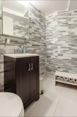 a bathroom with a sink and a toilet at Lovely Room at 3 bedroom Apt at the heart of East Village in New York