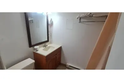 a bathroom with a sink and a mirror at Werry's Cottages Motel & Pub by OYO East Stroudsburg Poconos in East Stroudsburg