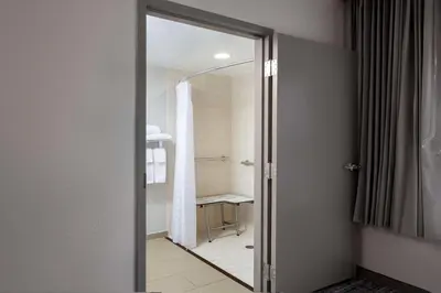 a bathroom with a glass door leading to a shower at Hyatt Place Mt. Laurel in Mount Laurel