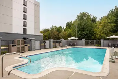 a large swimming pool in front of a building at Hyatt Place Mt. Laurel in Mount Laurel