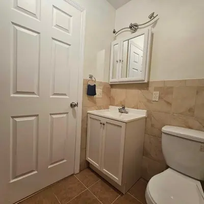 a bathroom with a white toilet and a sink at Divine Villa and Resorts 67 Sherman 5mins to EWR Airport and 4mins to Penn Station Newark, 20Mins to New York in Newark