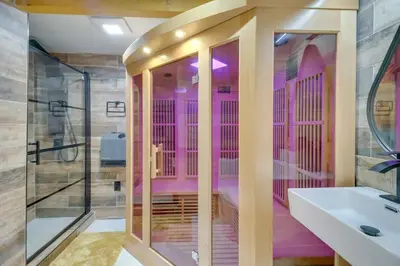 a pink bathroom with a shower and a sink at Pocono Getaway A frame Cabin w/ Hot Tub Sauna in East Stroudsburg