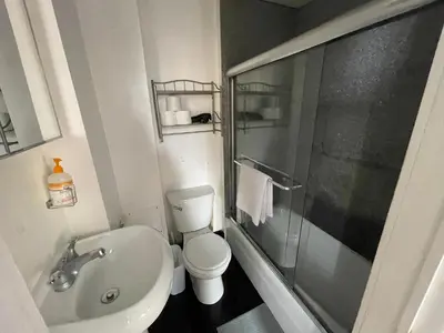 a bathroom with a toilet and a sink and a shower at Nest aparthotel with kitchenette in New York