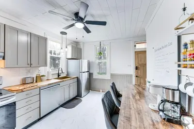 a kitchen with a table and a ceiling fan at Pet and Family Friendly! Home with Fenced Yard and Deck in York Haven