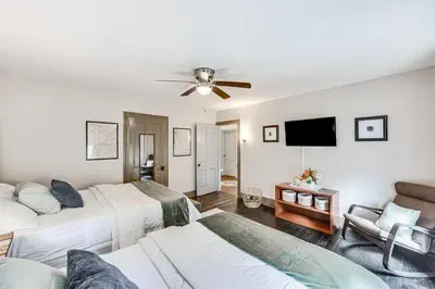 a bedroom with two beds and a flat screen tv at Pet and Family Friendly! Home with Fenced Yard and Deck in York Haven